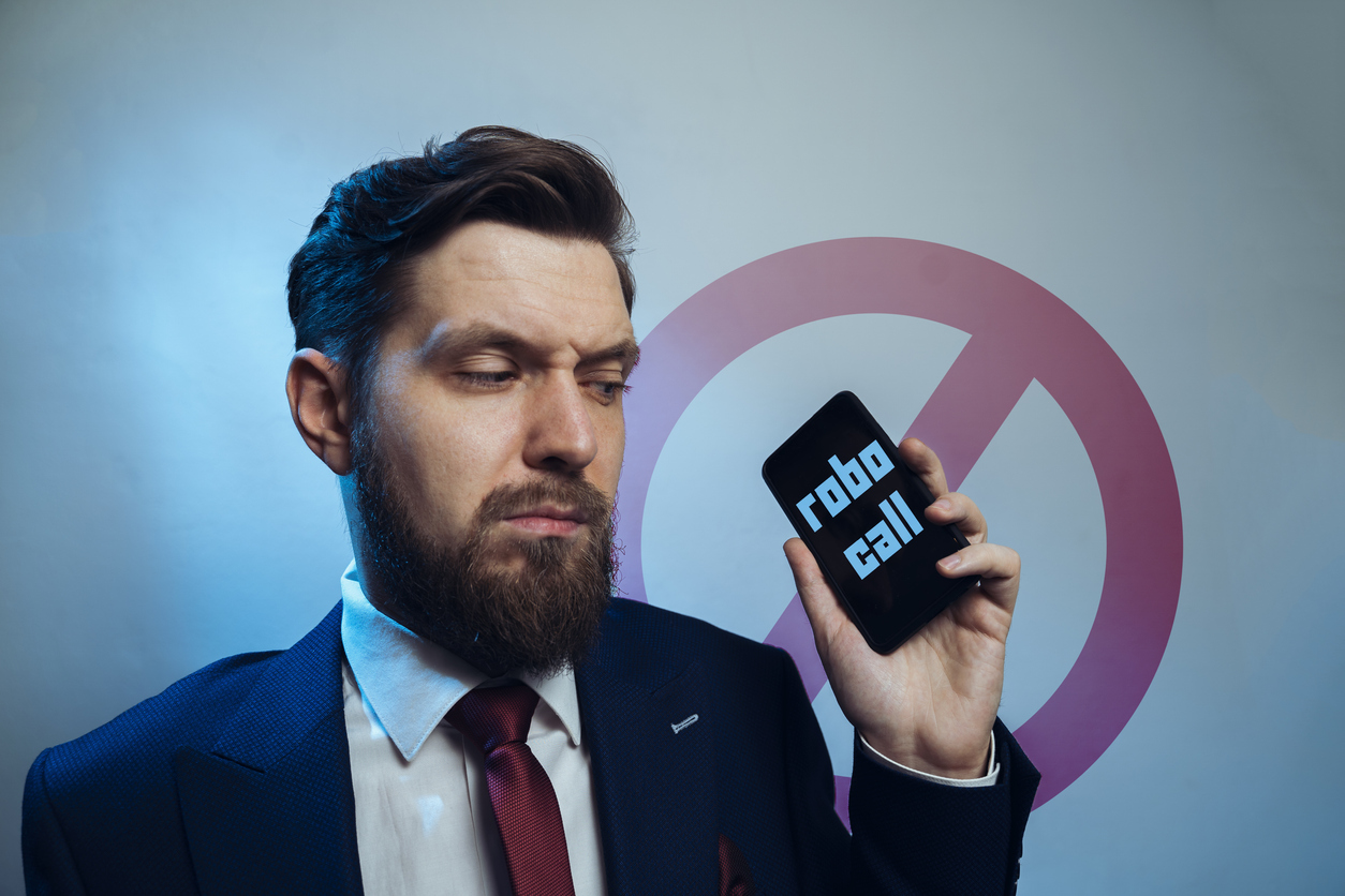 Man frowning receiving telemarketing robocall